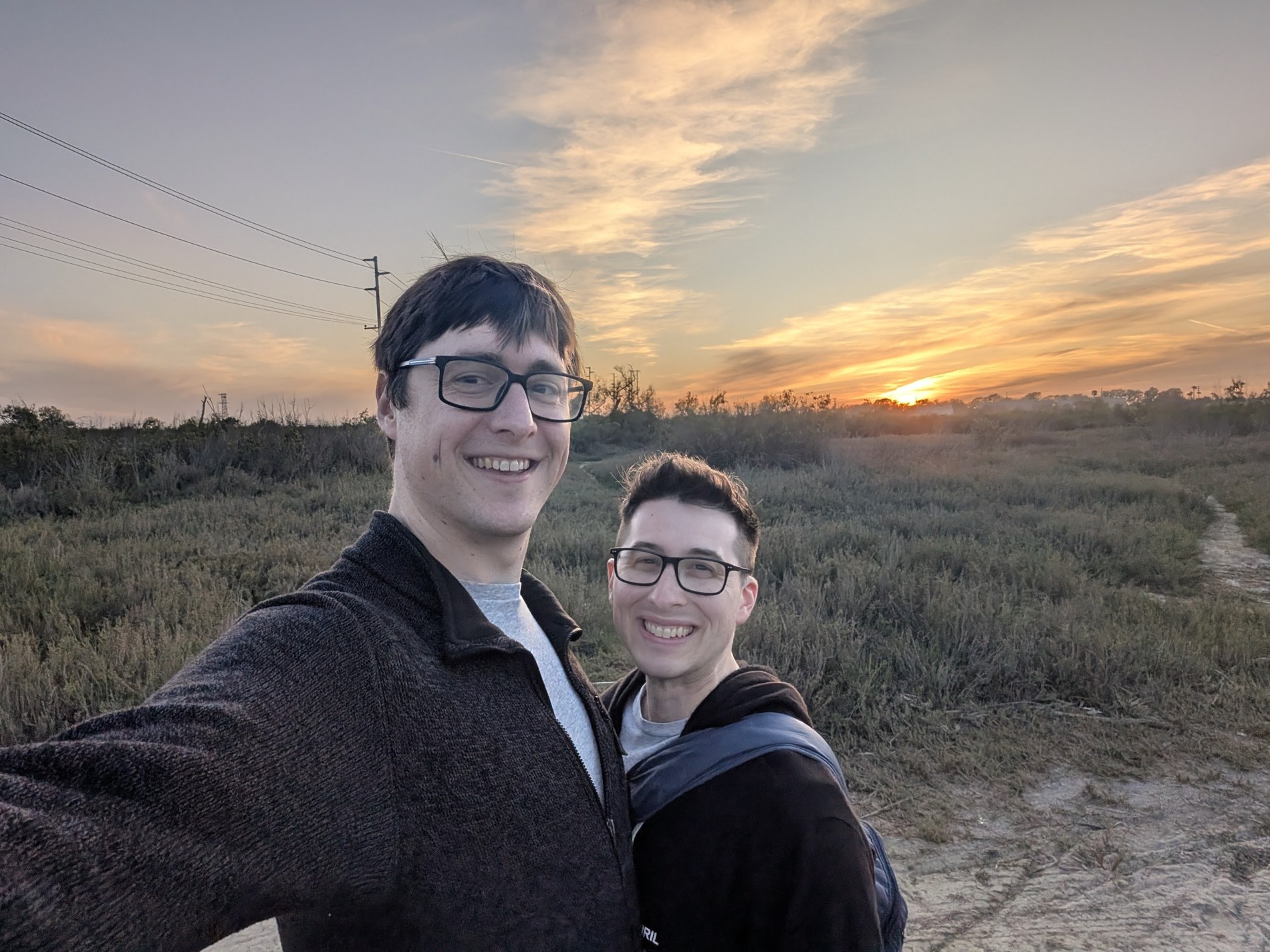 Aaron and Peter in a field at sunset