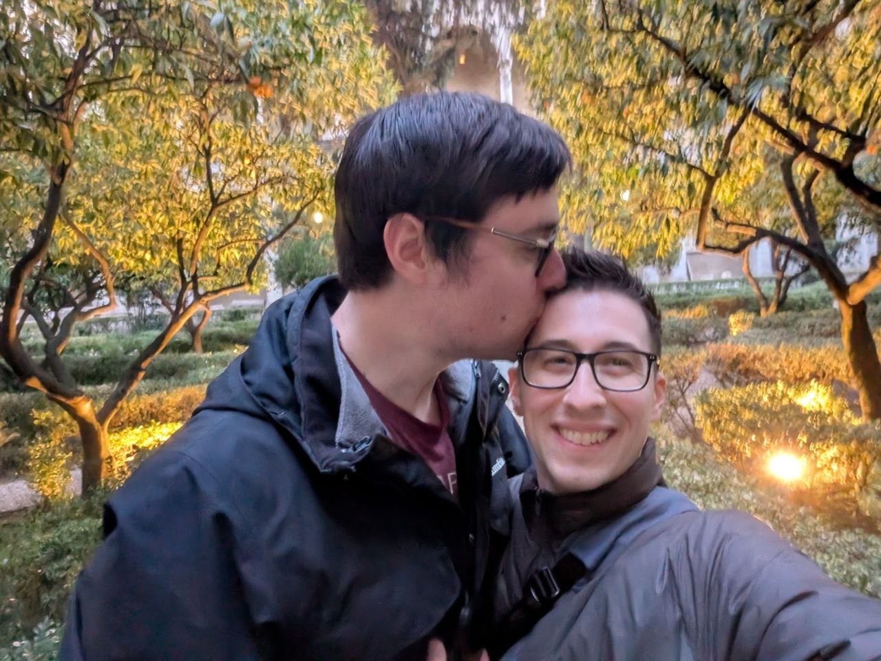 A kiss beneath golden autumn leaves